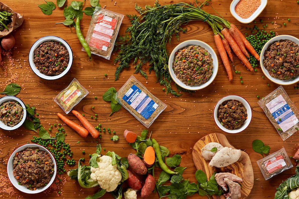 Picture of a bowl of food presented on a table with meat and sweet potatoes