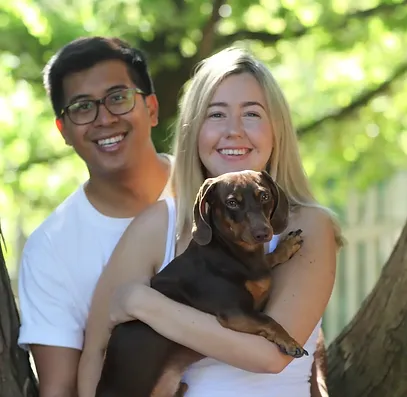 Photo of Liv and CJ holding a dog.